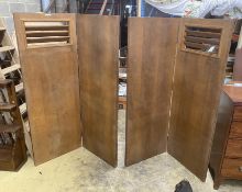 A pair of mid century oak two-fold dressing screens, with Bowman Bros. Camden, Ltd., trade labels,