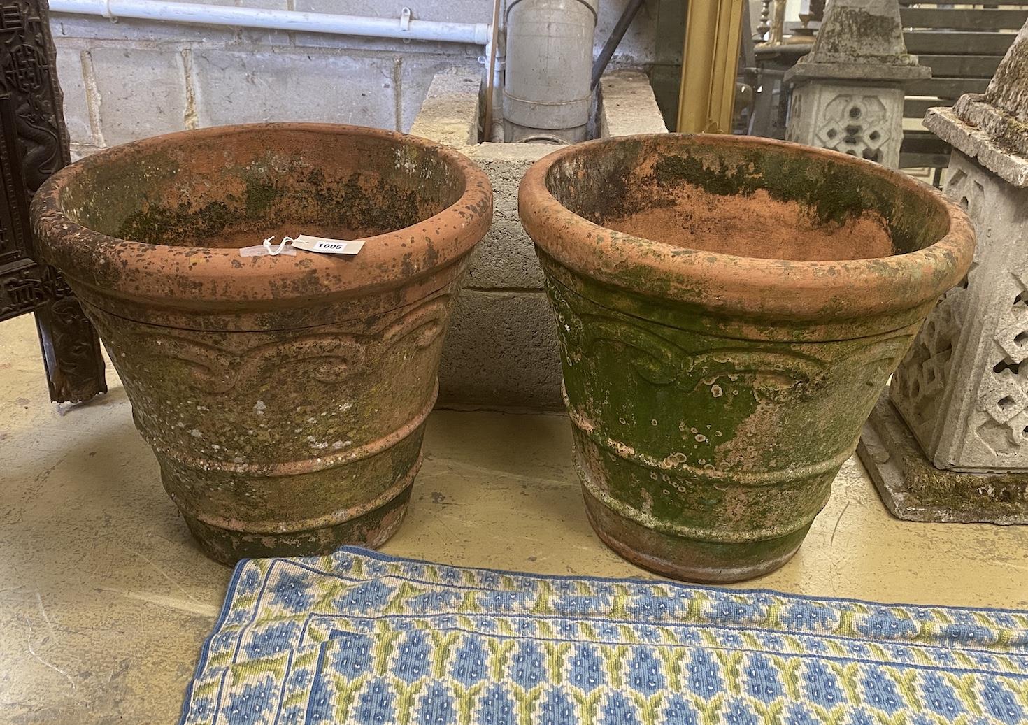 A pair of circular weathered terracotta garden planters, diameter 54cm, height 51cm