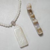 A Chinese white jade pendant and a jade brush rest