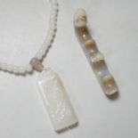 A Chinese white jade pendant and a jade brush rest