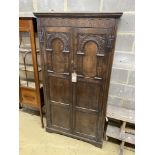 An 18th century style carved oak hall cupboard, width 97cm, depth 35cm, height 179cm