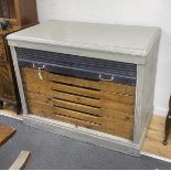 A mid century painted plan chest with tambour shutter, width 127cm, depth 69cm, height 102cm
