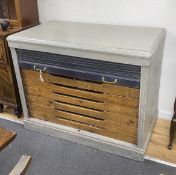 A mid century painted plan chest with tambour shutter, width 127cm, depth 69cm, height 102cm