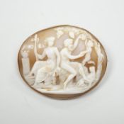 A gold mounted cameo brooch, carved with a classical family, width 4cm