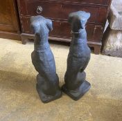 A pair of painted cast stone seated greyhound garden ornaments, height 74cm