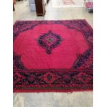 An Afghan red ground carpet, 330 x 314cm