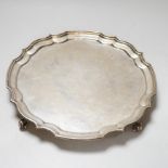 An Elizabeth II silver salver, with 1960 presentation inscription, piecrust rim and scroll feet,