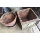 A square weathered terracotta garden planter, width 52cm, height 50cm together with a circular