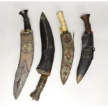 A kukri within white metal mounted sheath, blade 27cm, and three others, one with bone handle