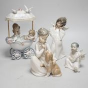 A large Lladro figure of children in a pram, seven models of angels and a boy with a dog (9)