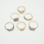 Six assorted gold dress rings, comprising an 18ct gold and platinum three stone ring, size O, an