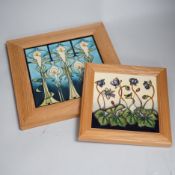 Two framed Moorcroft tiles, one with stylised lilies, the smaller tile with cyclamen, larger tile