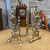 A pair of early 19th century brass fire dogs, height 42cm