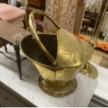 A 19th century Dutch embossed brass coal scuttle with swing handle together with a Victorian