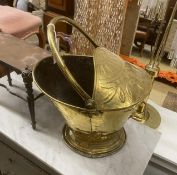 A 19th century Dutch embossed brass coal scuttle with swing handle together with a Victorian