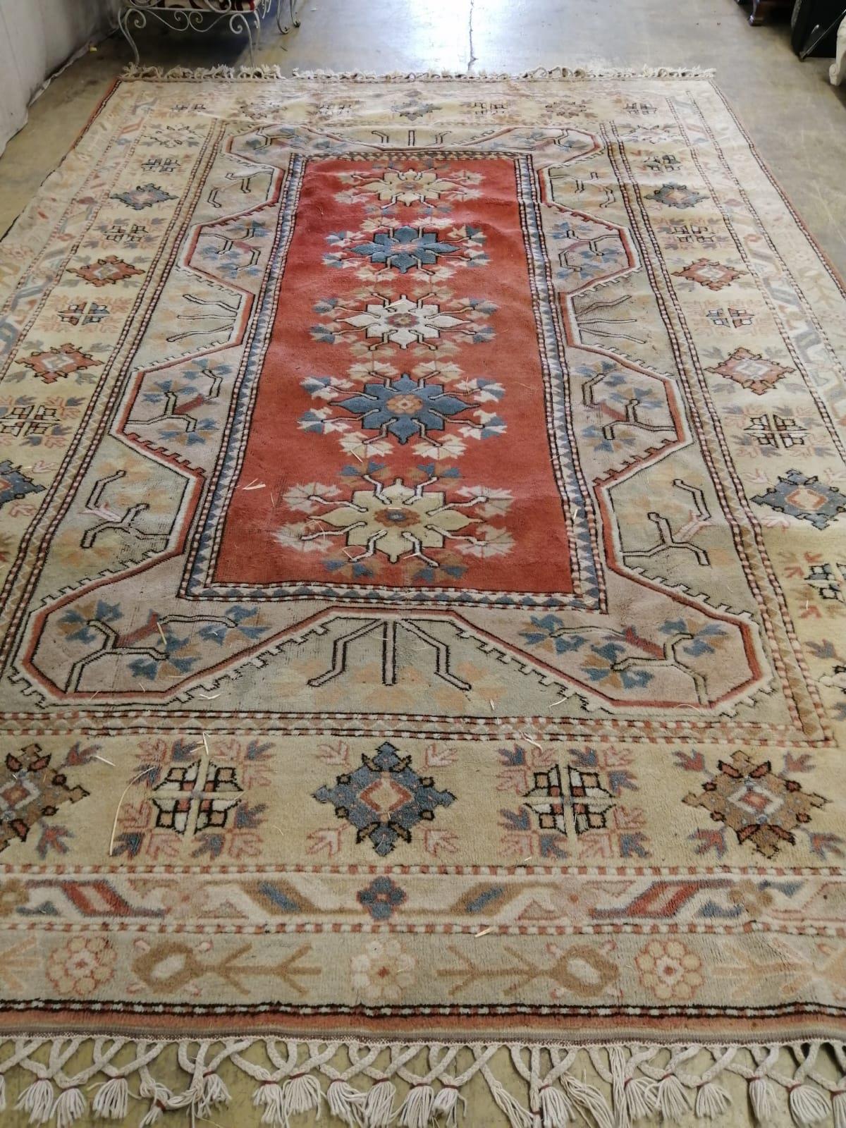 A Caucasian style red ground carpet, 380 x 266cm