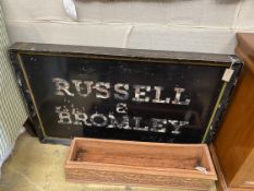 A vintage rectangular painted 'Russell & Bromley' advertising sign, length 123cm, height 78cm