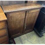 A George III oak two door side cabinet, (adapted) width 100cm, depth 32cm, height 102cm