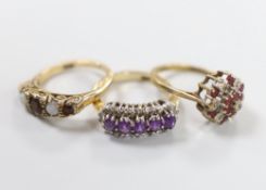 Three 9ct gold dress rings: white opal and ruby, size L, diamond and amethyst, size L and ruby and