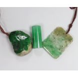 Two jadeite pendants and a handle tip