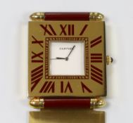 A Must de Cartier quartz travelling timepiece, with two red suede pouches and paperwork, 6.5cm