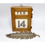 An oak desk calendar and a cast iron ‘leaf’ thermometer, 39cm