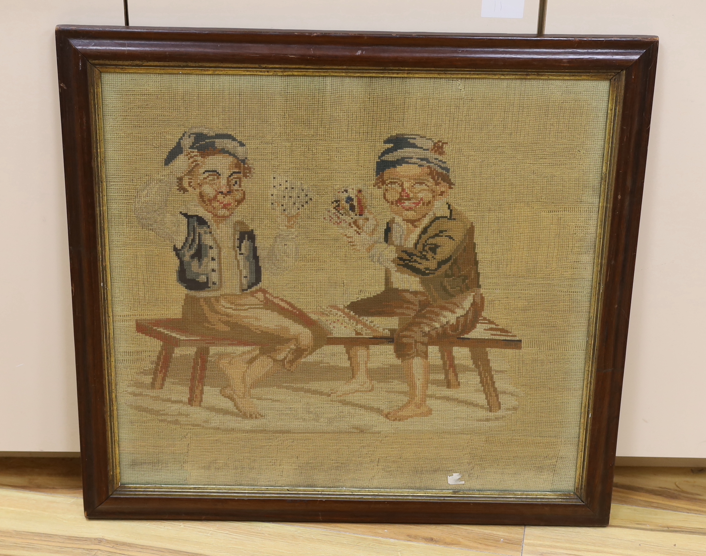 A Victorian woolwork panel depicting children playing cards, framed, 62 x 56cm