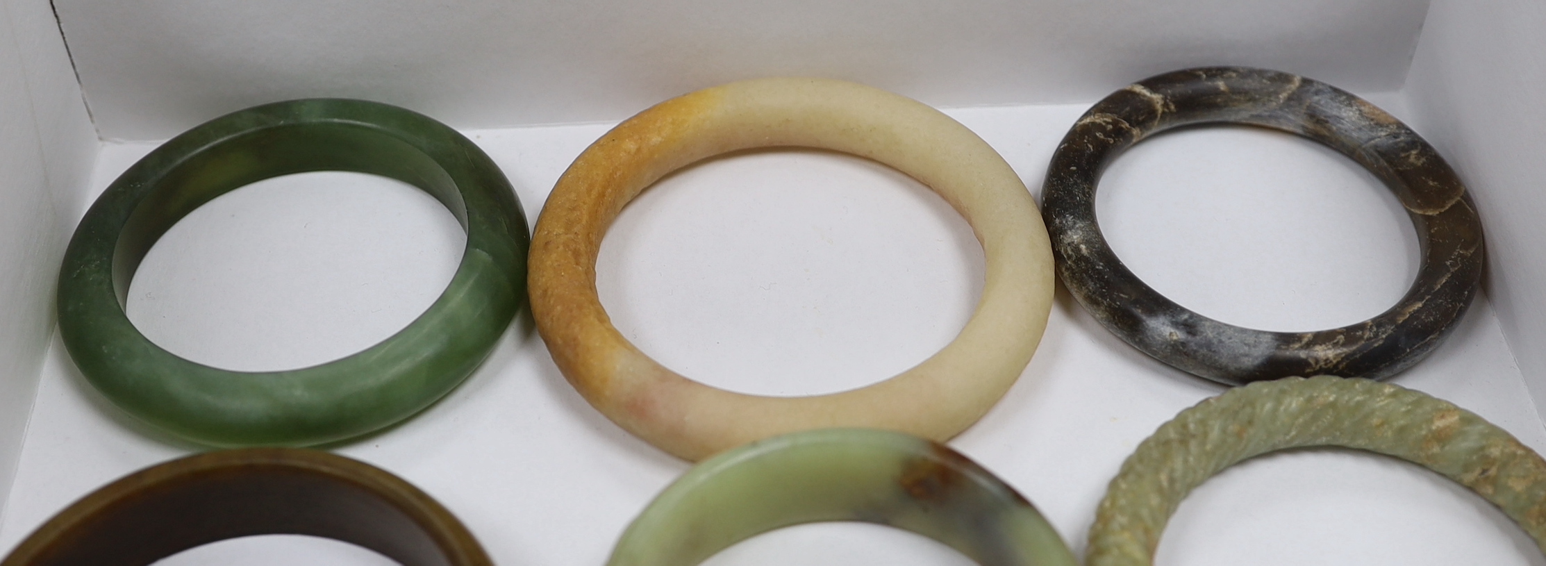 Eleven Chinese jade or hardstone bangles, largest 9cm - Image 4 of 4