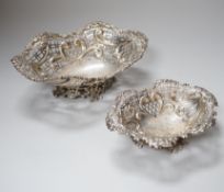 A graduated pair of Victorian pierced silver bon bon dishes, each with crest and motto, retailed