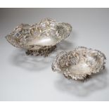 A graduated pair of Victorian pierced silver bon bon dishes, each with crest and motto, retailed