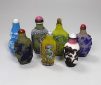 Seven Chinese overlaid glass snuff bottles, tallest 10cm high