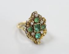 A yellow metal emerald and diamond ring of antique design, size L
