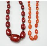 A simulated graduated red amber bead necklace, 52cm and an orange agate bead necklace, 92cm