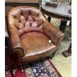 A Victorian mahogany buttoned faded red leather club chair, width 78cm, depth 83cm, height 75cm