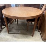 A mid century circular teak extending dining table, length 130cm extended, two spare leaves, depth