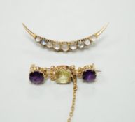 A gold and moonstone crescent shaped brooch, 4.7cm, gross 2.7 grams and an amethyst and gem set