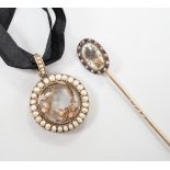 A late Victorian gold and split pearl circular locket, 3.5cm and a Regency stick pin with central