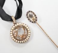 A late Victorian gold and split pearl circular locket, 3.5cm and a Regency stick pin with central