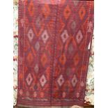 A North West Persian Jadjim geometric red ground carpet 284cm x 140cm
