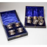 A cased set of six Edwardian silver napkin rings, Birmingham 1910, 71 grams and a cased set of