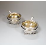 A pair of Victorian circular silver salts, with crests and scroll feet, makers Edward Barnard &