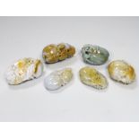 Six Chinese jadeite 'pebble' carvings including one of bars and fruit, 8cm wide