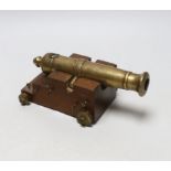 A miniature bronze table cannon on stepped base, 20cm wide