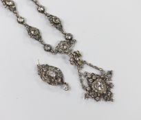 An ornate white metal and paste pendant necklace, with similar drop earrings