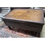 A rectangular embossed leather covered mahogany coffee table on turned feet, incorporates old