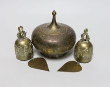 A pair of Eastern brass bells and lidded jar, largest 12cm high