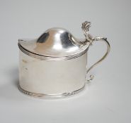 A George III oval silver drum mustard, with domed cover, glass liner and plated spoon, makers Peter,