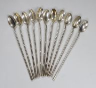 A set of eleven Asian white metal long handled spoons, stamped 925