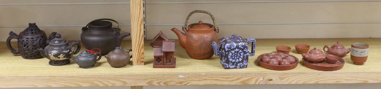 A quantity of Chinese Yixing teapots and terracotta tea bowls, the largest 20cm wide