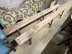 A pair of Provincial pine and fruitwood benches, length 250cm, width 17cm, height 45cm